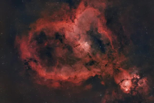 The red Heart Nebula surrounded by stars