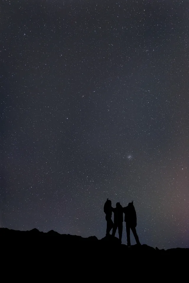 A silhouetted stargazer beneath the Milky Way